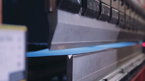 Pressing Sheet Metal On A Machine Tool Factory. Worker Puts The Steel Sheet In The Installation. ...