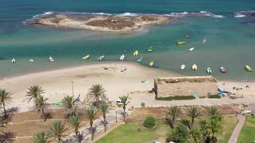 Small Fishing Boats anchored in a shallow lagoon, with packed Fish net onboard, Aerial view