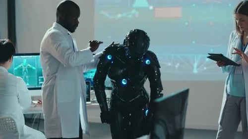 Robot Testing in Professional High Tech Laboratory Three Multiethnic Robotic Specialists Perform