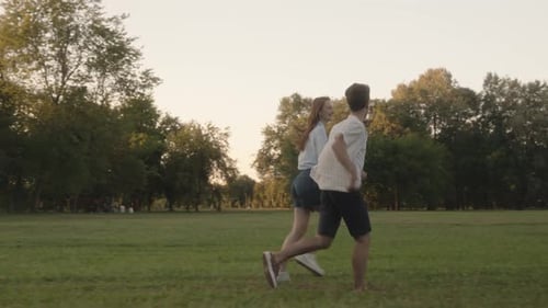 Couple Running Through Park