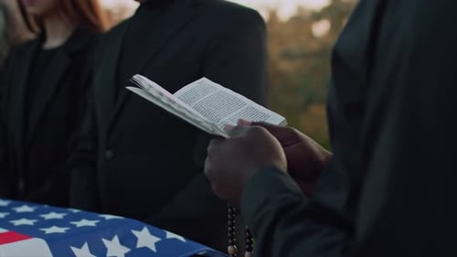 Holding Funeral Service with Prayer Book and Beads