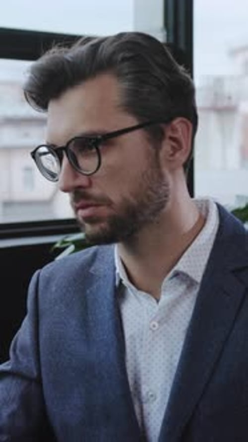 A Stylish Professional Male Working Diligently in a Contemporary Modern Office Space