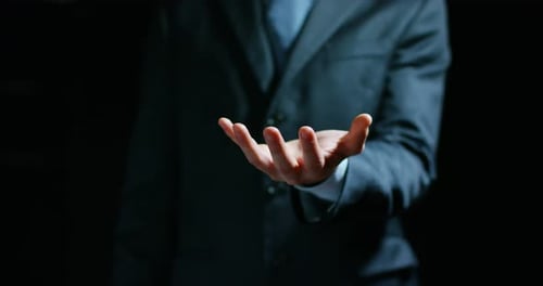 Open Palm Hand Wearing Suit in Darkness