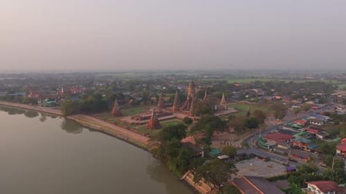 Drone view of Buddhist temple reflecting the first rays of sun