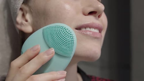 Woman Using Silicone Facial Cleanser for Skincare Routine
