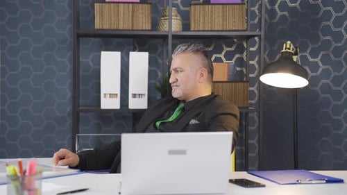 Man Working on Laptop in an Office