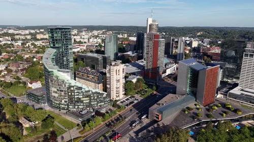 Drohnenantenne über einem modernen Geschäftsviertel mit gläsernen Wolkenkratzern, Büros und belebten Straßen auf einem