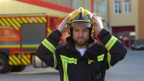 Fireman Removes the Protective Helmet in Fire Department