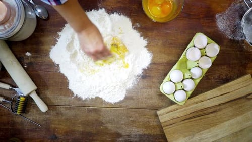 Mixing Dough for Baking on Rustic Wooden Table