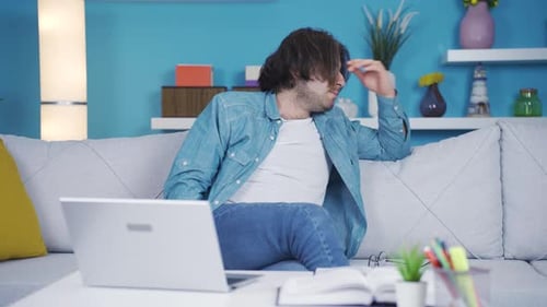 Man Frustrated While Using Laptop at Home