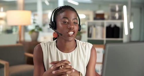 Professional Woman Communicates Using Headset in Modern Office