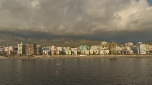 Aerial View A Breathtaking View of the City Stretching Toward the Horizon with the Ocean Creating a