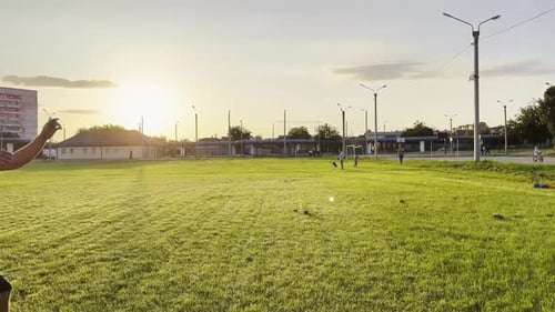 Two Sportsmen Showing Tricks with Ball While Passing It to Each Other at Field Young Men Kicking