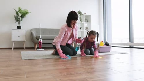 Mom Rubbing Laminate with Cloth Together with Daughter