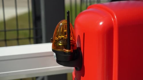 Electrician connects the yellow Signal Lamp for the gate. Warning yellow flash lamp