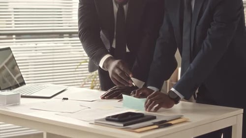 Businessmen Doing Paperwork in Office