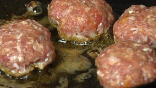 Meat patties or cutlets in form of cutlets, fried in oil in pan,
