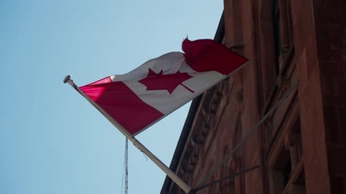 Canadian Flag Waving Proudly on Sunny Day