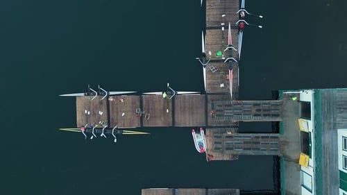 Rowing Boat Teams Finish Training Carry Gear And Boats On Dock Aerial View