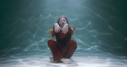 Underwater Woman Stretching In a Pool