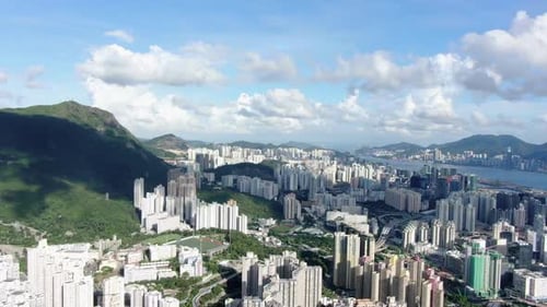 Breathtaking Aerial Panorama of a Vibrant Coastal City and Mountains