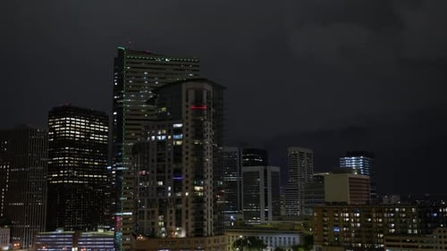 Lightning in night sky over city of Denver skyline and illuminated buildings
