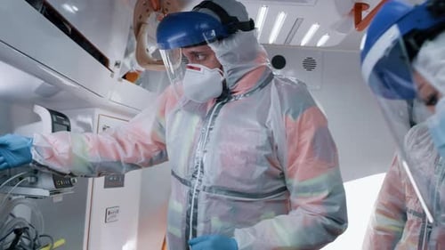 Medical Team Caring for Patient in Ambulance