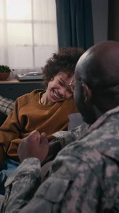 Child and Adult in Military Uniform Talk at Home