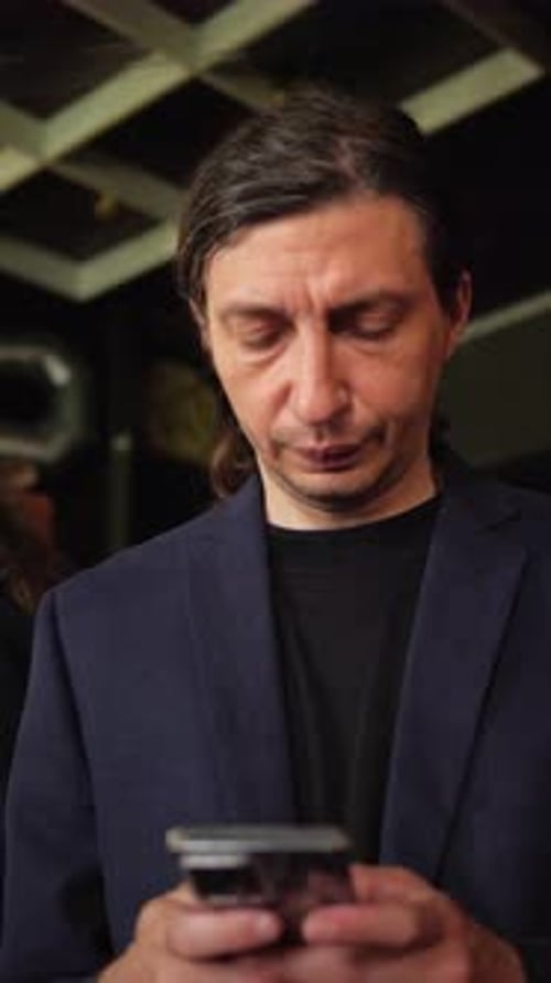 Man Using Smartphone with Focused Expression