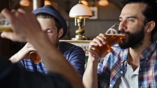 Men Drinking Beer and Eating at a Pub