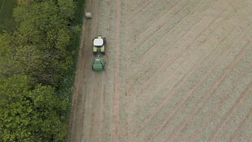 Drone shot of a tractor working in a field.
