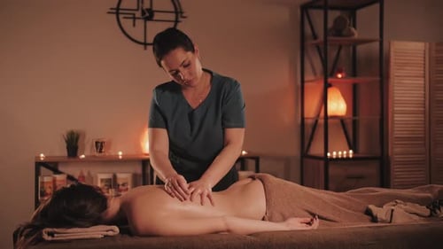 Master makes a professional massage, spa salon. Relaxing and healthing procedure.