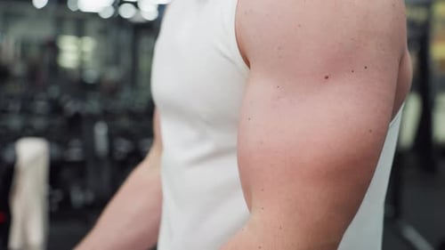 Bodybuilder Arm Flexing During Cable Curl Session