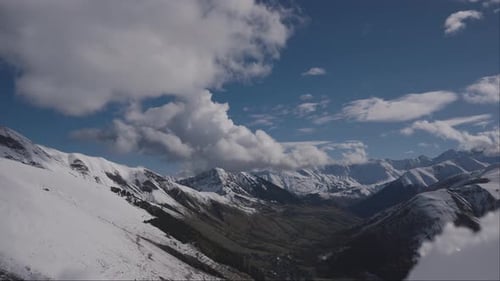 The Scenic Snowy Mountain Range Under a Blue Sky Creates a Breathtaking Landscape for Adventure