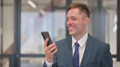 Adult Man Celebrating Success While Looking at Phone