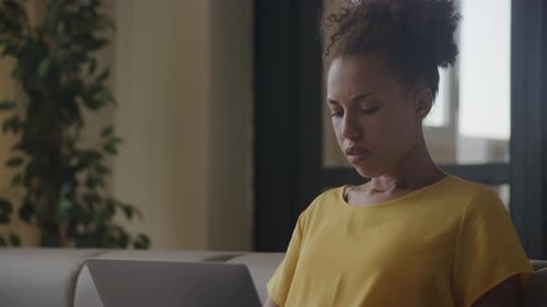 Upset Woman Reading Bad News on Laptop