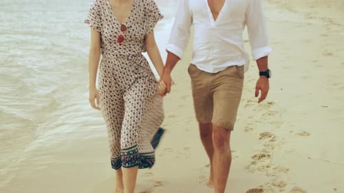 Young Couple Walking Near the Shore Along the Beach in Australia With