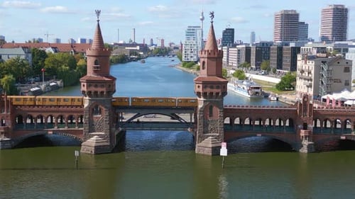 subway train Summer day east west Berlin Border River Bridge Germany. Fantastic aerial top view flig