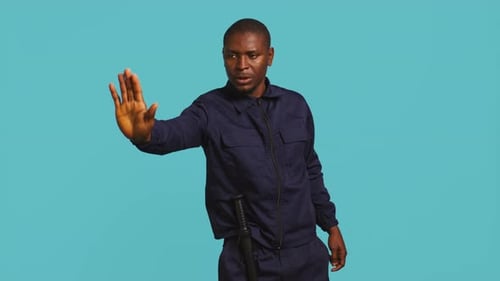 Man Gesturing Stop with a Baton