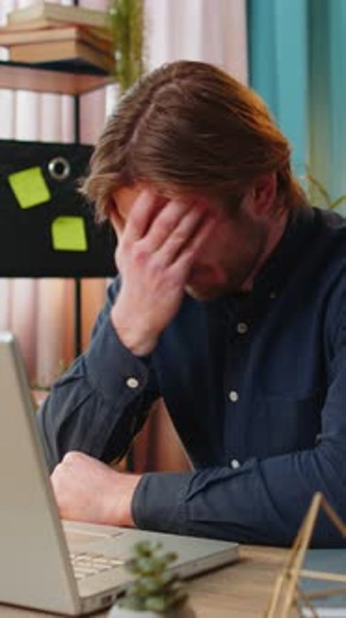 Bored Sleepy Businessman Worker Working on Laptop Computer Yawns Leaning on Hand Sleeps at Office