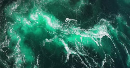 Blue waves of water of the river and the sea meet each other during high tide and low tide.