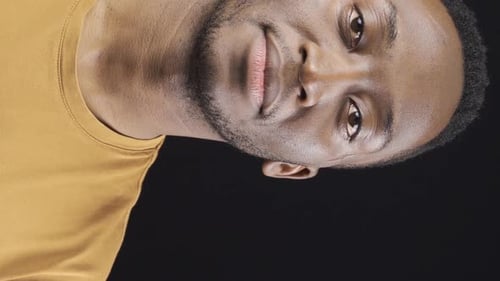 Vertical Video of Close-up portrait of smiling friendly african young man.
