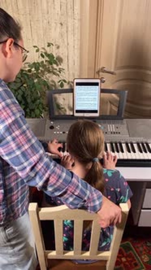 Girl Learning Piano with a Teacher at Home