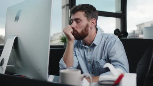 Un professionnel concentré travaillant à un bureau entouré de technologies et d'outils modernes