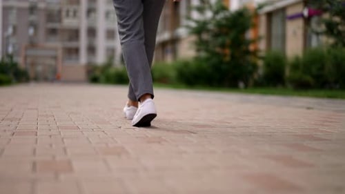 Woman Walk in City Close Up View of Legs and Feet Dressed in Casual Style Bottom View of Body