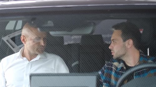 Two Men Having a Conversation in Car
