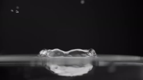 Drop is Falling Into Water Macro Shot Crystal Clear Liquid Splash Abstract Dark Background Concept
