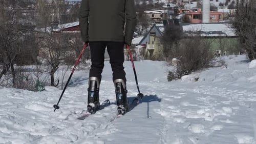 Man Skiing Down Snow Covered Hillside