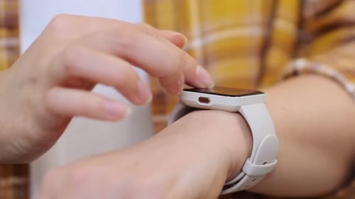 Woman Interacts With Smartwatch on Her Wrist