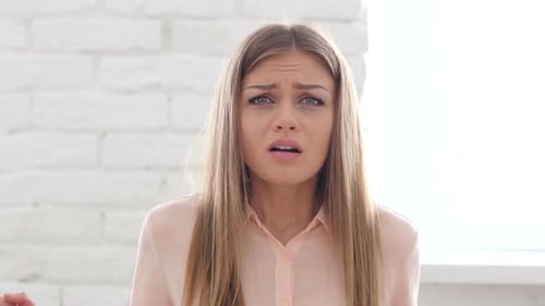 Worried Woman Looking Anxious in White Room